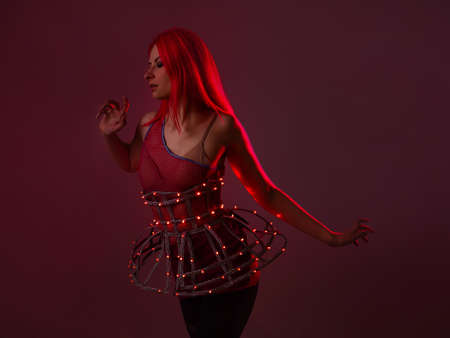 Light show, suit with LEDs. Young beautiful woman in a luminous suitの写真素材
