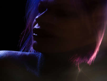 Fashionable young woman with blue-purple hair, stylish shining makeupの写真素材