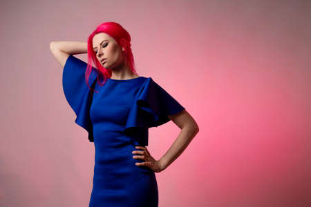 Beautiful and stylish blue outfit on a young attractive womanの写真素材