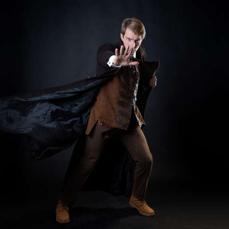 character of the steampunk story, a young attractive man in an elegant long coat