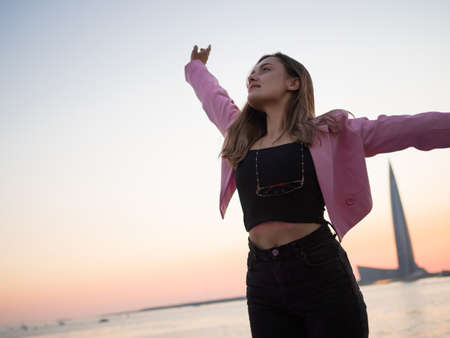 Stylish and free, a young woman in a bright jacket
