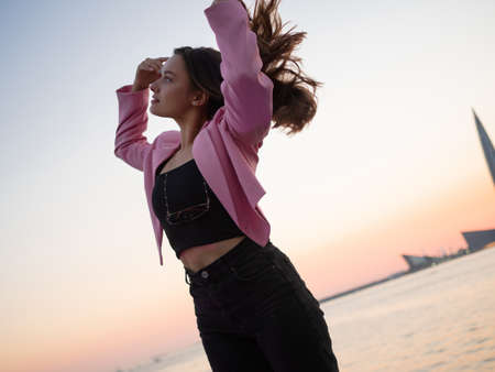 Stylish and free, a young woman in a bright jacket