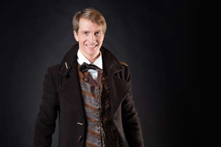 character of the steampunk story, a young attractive man in an elegant long coat