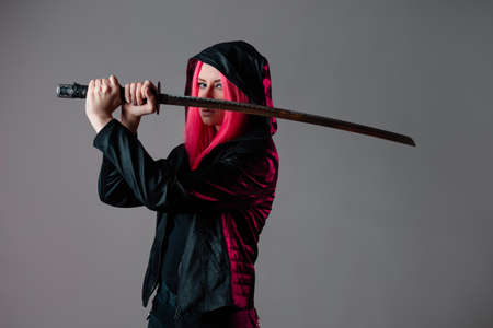Techno cyber punk style, futuristic ninja, young woman with pink hairの写真素材