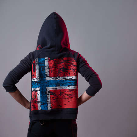 woman in a hooded sweatshirt with the flag of Iceland on the back,の写真素材
