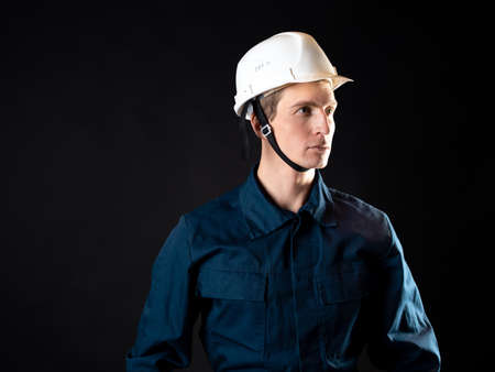 A builder or repairman, a man in a robe and a protective helmetの写真素材