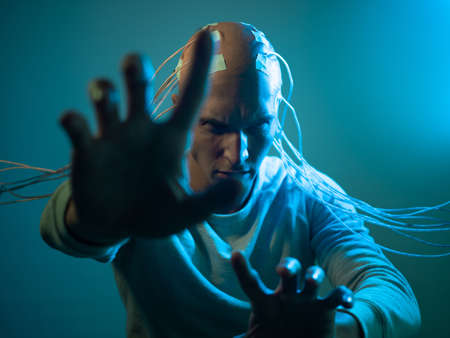 scary young man with his head entangled in wires, uses mind control and telekinesis, electrical...