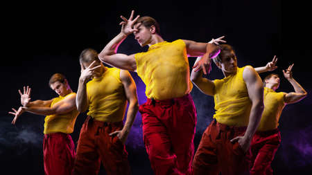 a young muscular man in a bright outfit poses in a pretentious pose, collage of several poses. An...