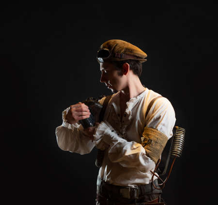 A guy in a steampunk image, a pilot or a mechanic. Retro style, fantastic image. Repairs the steam...