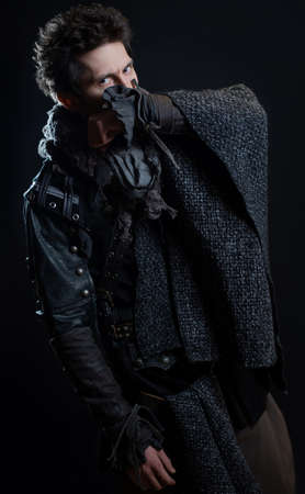 A guy in a steampunk or post-apocalyptic image, portrait on a black backgroundの写真素材