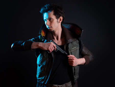 A guy in a cyberpunk image, pulls out a gun. a futuristic character. A young man in neon lighting on...