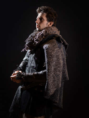 A guy in a steampunk or post-apocalyptic image, portrait on a black backgroundの写真素材