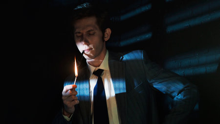 A serious young man lights his pipe with a match, a man in a gray suit with a tie holds a burning...