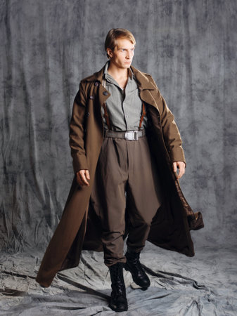hero in a military style with a gun in his hands, a young man in a long brown coat and breeches with...