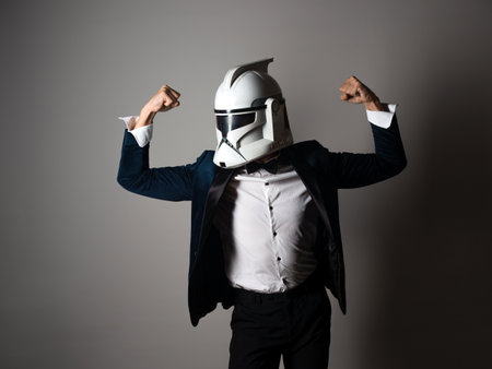 SAINT PETERSBURG, RUSSIA - SEPTEMBER 29, 2020: Respectable man in a tuxedo with a bow tie and a helmet of a combat star stormtrooper, business geek, illustrative editorialのeditorial素材