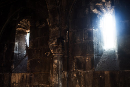 Divine light , the interior of an ancient church, unity with God. Geghard Monastery in Armenia. The Monastery of the spear,の写真素材