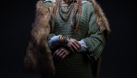 Attractive young blonde, woman in a Viking-style fantasy costume. skirt with shirt and fur cape, Scandinavian style, Hands close-up, detailsの写真素材