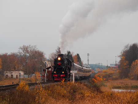 Karelia, Russia - October 10, 2021: Vintage soviet steam train locomotive. Karelian Express, autumn...