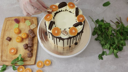 cook a cake in the kitchen. Young female pastry chef cooking a beautiful high sponge cake, pastry chef works at home, bright kitchen, video of the processの写真素材