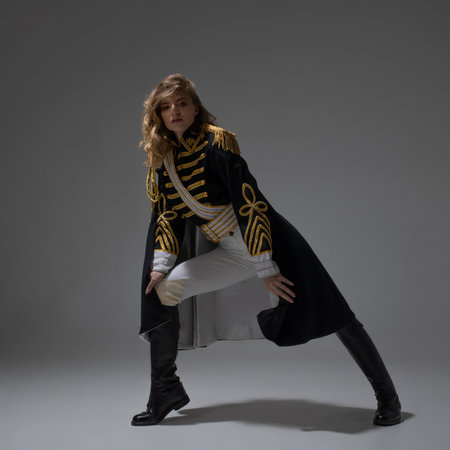 A glamorous blonde in a carnival uniform with epaulettes, posing with pretentious poses, a show host or a pop artistの写真素材