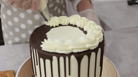 cook a cake in the kitchen. Young female pastry chef cooking a beautiful high sponge cake, pastry...