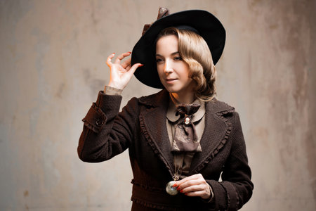 Stylish lady in an elegant suit in Victorian style, in a hat, close-up portraitの写真素材