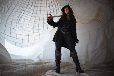 A pirate lady in a hat with a saber in her hands, a beautiful young brunette in a pirate costume,...