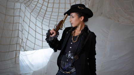 A pirate lady in a hat with a vintage pistol in her hands, a beautiful young brunette in a pirate...