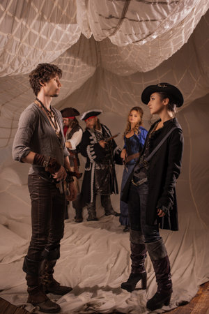 A merry band of pirates, a group photo in carnival costumes, corsairs on the background of sails