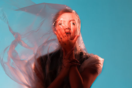 Compress and limit yourself from the outside world, portrait under cellophane, concept
