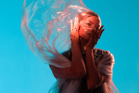 Compress and limit yourself from the outside world, portrait under cellophane, conceptの写真素材