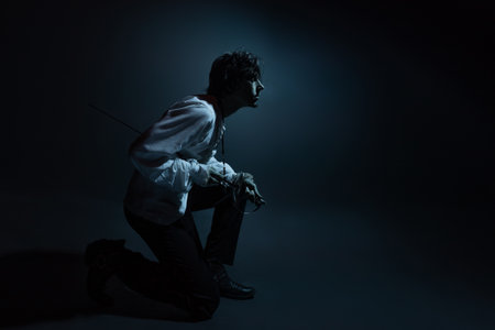 A dramatic hero with a sword in his hands, suffering from defeat and injury, a portrait in the moonlight, drama or theaterの写真素材