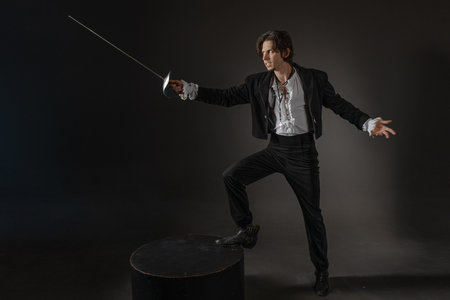 The romantic hero is a duelist in a dynamic fighting stance, the style of classical theatrical productionsの写真素材