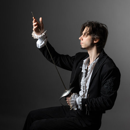 The romantic hero is a duelist in a medieval costume, the style of classical theatrical productions