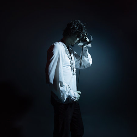 A dramatic hero with a sword in his hands, suffering from defeat and injury, a portrait in the moonlight.の写真素材