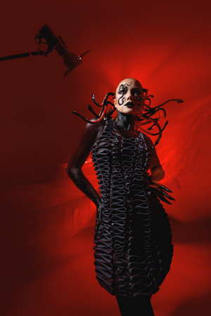 Snake woman, stylish and daring woman, snake pattern makeup, snake hairstyle, bright photo on a red...