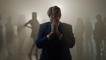 A young man is stressed and there are many ex-partners in the background.の写真素材