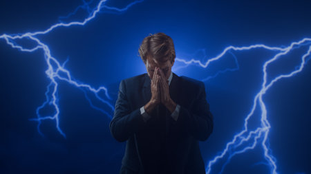 A man in a business suit is stressed. A businessman is tense. Electric lightning bolts spark around him.の写真素材