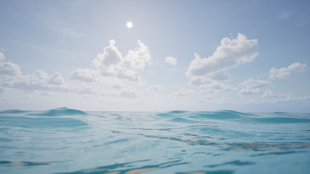 A minimalistic ocean scene with calm waves, clear water, and a serene horizon. White clouds dot the sky, creating a peaceful, natural background perfect for summer, travel, or relaxation themes.の写真素材