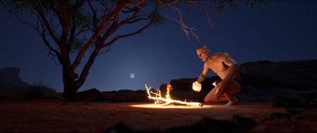 An ancient man, representing early human development, uses flint to create fire in a desert savannah at twilight. He ignites a bonfire, symbolizing evolution, progress, and the dawn of human ingenuity. The scene captures a pivotal moment in history and archeology.の写真素材