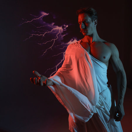 A muscular, athletic figure embodying Zeus, Lightning bolts in hand, and a red warning light symbolizes strength, might, and mythical rulership.の写真素材