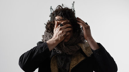 A self-made king on the ruins of the world, a creative concept in the style of Shakespeare. Hamlet in modern grunge or post-apocalyptic reinterpretation, tragic Shakespearean hero in a crown of wireの写真素材