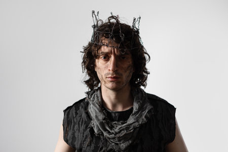 Hamlet in modern grunge or post-apocalyptic reinterpretation, young man, tragic Shakespearean hero in a crown of wireの写真素材