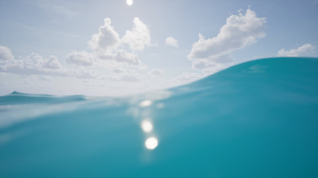 A calming ocean scene with gentle waves, clear water, and a minimalistic horizon. White clouds in the sky create a peaceful, natural backdrop for summer, travel, or relaxation designs.の写真素材