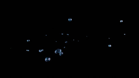 Chaotic water bubbles and liquid spheres float and splash in a 3D render on a black background. The gurgling effect mimics underwater breathing, creating an abstract, dynamic pattern for creative use.の写真素材
