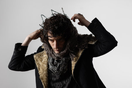 Hamlet in modern grunge or post-apocalyptic reinterpretation, young man, tragic Shakespearean hero in a crown of wireの写真素材