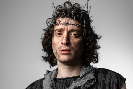 Hamlet in modern grunge or post-apocalyptic reinterpretation, young man, tragic Shakespearean hero in a crown of wire, dramatic hero,の写真素材