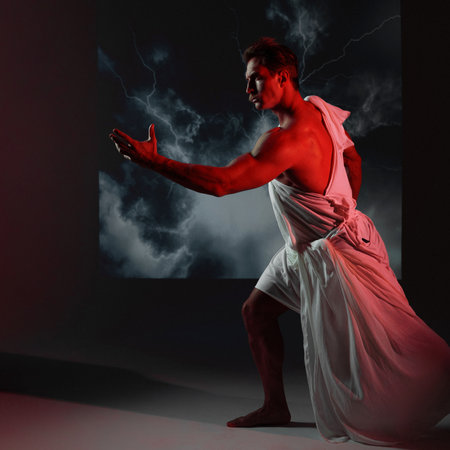 A muscular, athletic figure embodying Zeus, Lightning bolts on the background, and a red warning light . The scene captures the essence of Greek mythology, blending athleticism and divine power.の写真素材