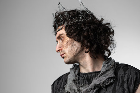 Hamlet in modern grunge or post-apocalyptic reinterpretation, young man, tragic Shakespearean hero in a crown of wireの写真素材