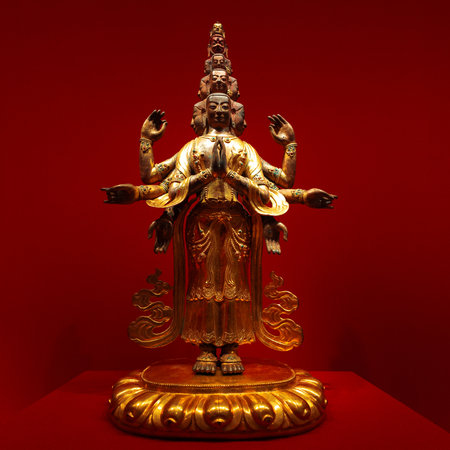 golden Avalokiteshvara Buddha statue with multiple arms and ornaments. Avalokiteshvara is the Bodhisattva of Mahayana Buddhism, the buddha of compassion, an emanation of Buddha Amitabha, embodies the ideal of universal compassion. frontallyの写真素材
